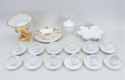 a lot of white and gold dishes and cups and saucers