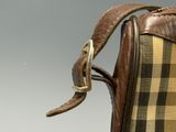 a brown and black checkered bag with a gold buckle