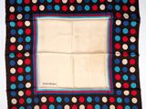 a close up of a square scarf with polka dots on it