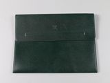 a black leather wallet sitting on top of a white table