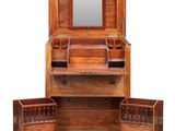 an antique wooden dressing table with drawers and a mirror
