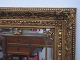 a mirror that is sitting on a table in a room