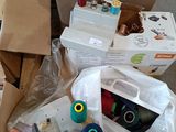 many boxes of sewing supplies on the floor next to each other