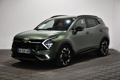 the green suv is parked on a checkered floor in a room