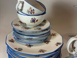 a lot of plates and cups sitting on a table
