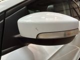 a side view mirror of a car that is parked in a lot
