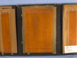 three pieces of wood sit on a blue surface with a tag on it