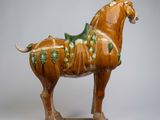 a statue of a horse with a saddle on it ' s back