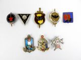 a lot of badges that are on a white surface