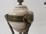 pair of antique brass and marble urns with lion heads on them