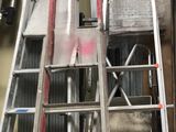 many ladders that are lined up in a garage
