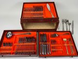 two trays with forks, spoons, and knives in them
