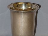 a silver cup that is sitting on a table