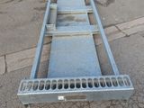 a metal ramp that is laying on the ground