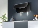 a black and white kitchen with a stove and oven