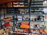 many boxes and bins on the shelves in the garage
