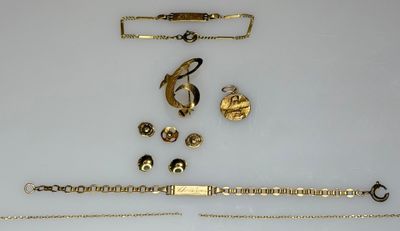 a lot of gold jewelry on a white surface