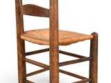 an old wooden chair with a woven seat on a white background