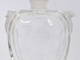 une bouteille en verre transparent avec un oiseau sur le bouchon