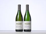 two bottles of wine sitting next to each other on a table
