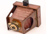 a small wooden box with a camera inside of it