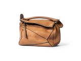 a brown leather handbag with a zipper on the front