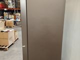 an image of a stainless steel refrigerator in a warehouse