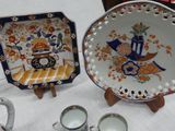two plates and cups on a table with a white table cloth