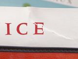 a piece of paper with the word nice written on it