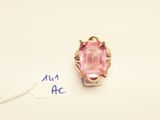 a close up of a ring with a pink stone in it