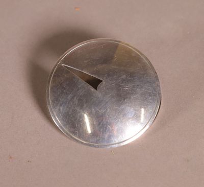 a silver button with a hole in the middle of it