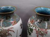two vases that are sitting side by side on a table