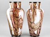 two vases sitting side by side on a gray surface