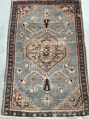 a rug with a pattern of flowers and leaves on a blue ground