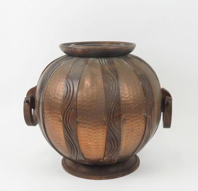 a metal vase with a handle on a white background
