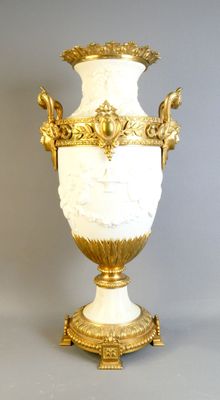 un vase blanc et doré posé sur une table