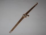 a watch that is laying on a white surface