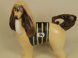 figurine of a dog with a baseball glove on it ' s head