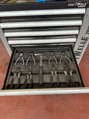 a lot of tools in a tool box on the floor