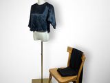 a mannequin and a chair in front of a mannequin