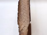 a sculpture of a leaf hanging on a wall