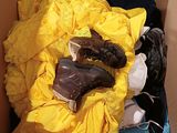 a box full of clothes and shoes inside of it