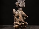 a wooden statue of a woman holding a child
