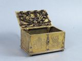 a gold box with a design on the inside