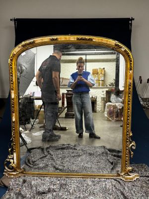 a man and a woman standing in front of a mirror