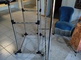 a metal stand with a pair of legs on it in a room