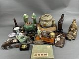 a lot of asian figurines and other items on the table