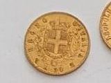 two pieces of gold coins with a coat of arms on them