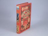 a red book that is sitting on a white surface