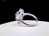 an image of a diamond and sapphire ring on a white surface